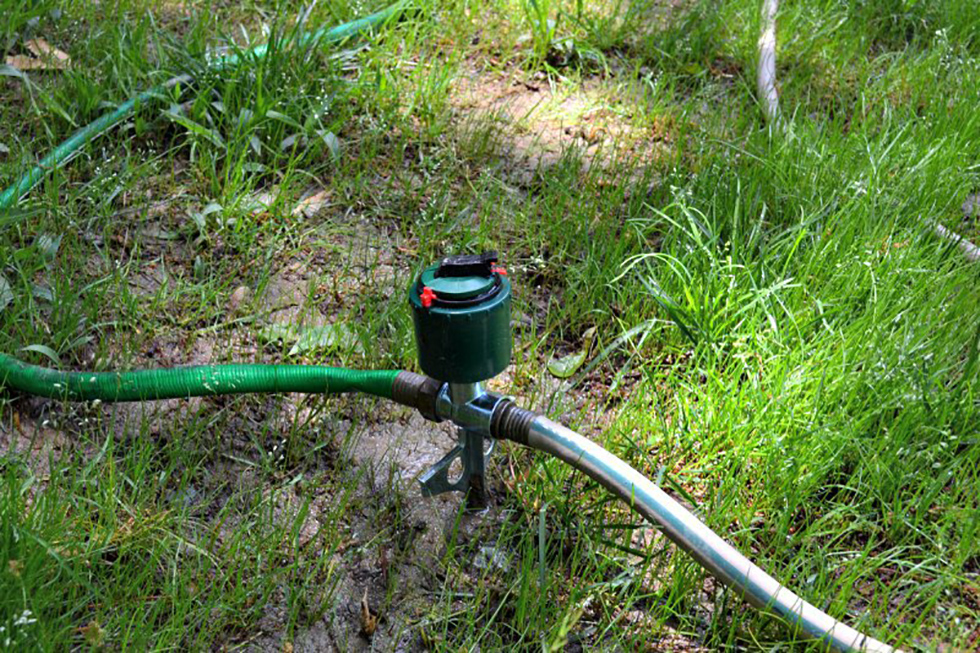 Close up of a sprinkler in grass