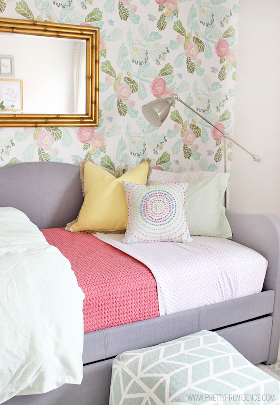 Day bed against pink and mint floral wallpaper