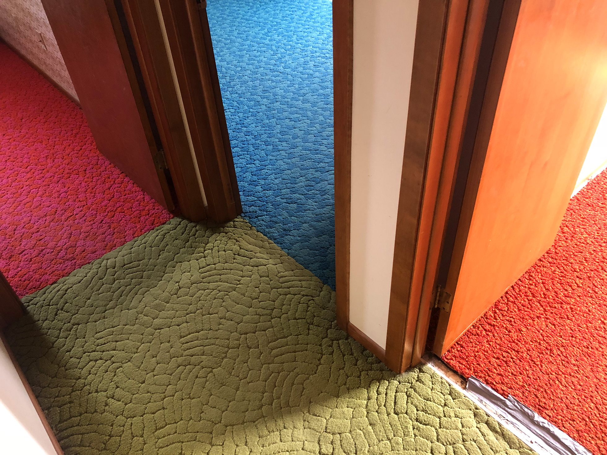 Multiple carpets in retro sixties colors converging